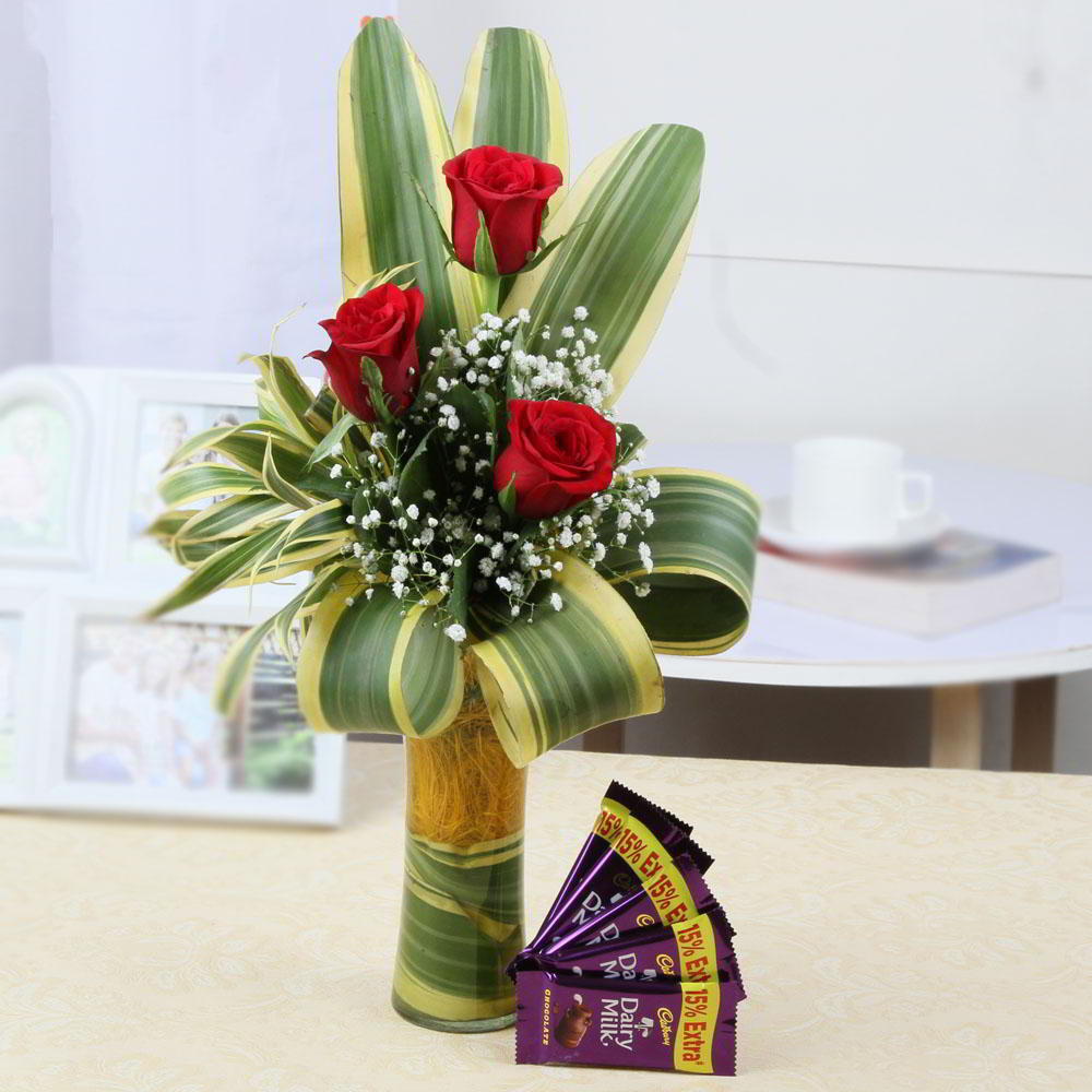 Dazzling Three Red Roses in Glass Vase with Dairy Milk Chocolates Combo
