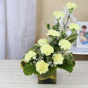 Bright Yellow Carnations in Glass Vase
