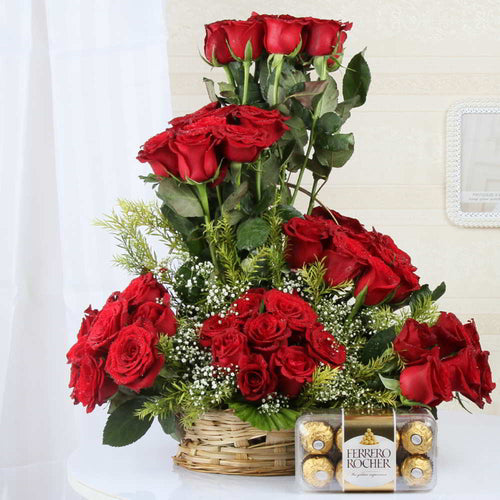 Arrangement of Fifty Red Roses in a basket along with Ferrero Rocher