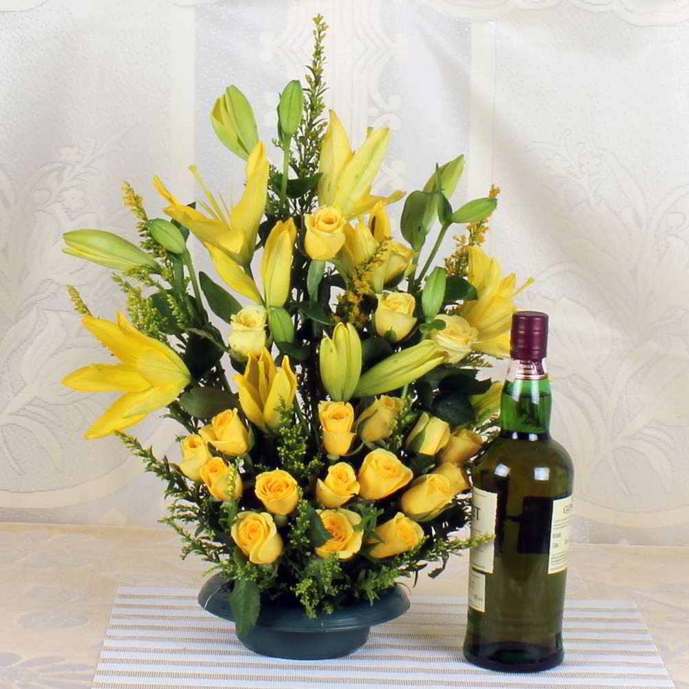 Arrangement of Yellow lilies and Roses with Bottle of Wine