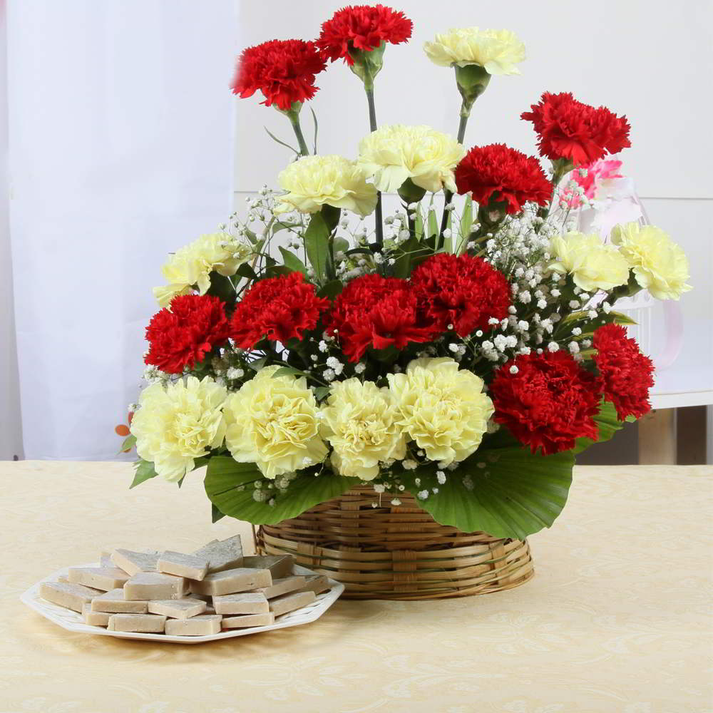 Basket Arrangement of Bright Carnations with Fresh Kaju Katli Sweet