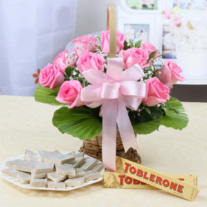 Ten Pink Roses Basket with Toblerone Chocolates and Kaju Sweets